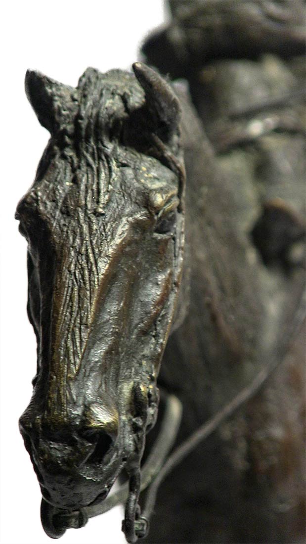 A western bronze sculpture horse and rider a sculpture by Jasper D'Ambrosi titled Holdin Herd