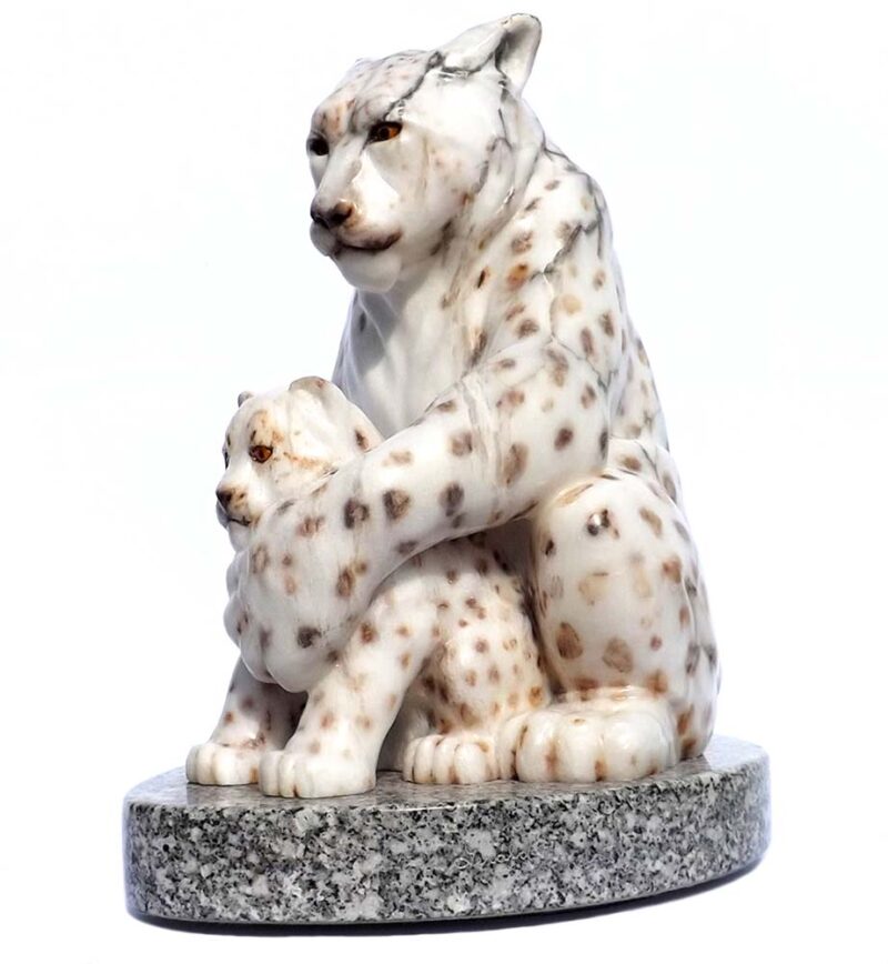 A Carved Stone Sculpture titled The Guardian (Snow Leopard & Kit) by Gerald Sandau
