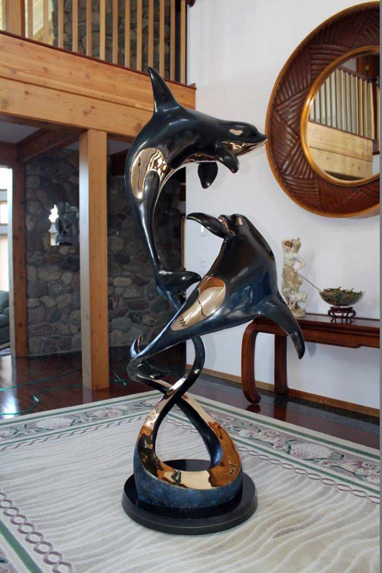 Two Orca’s in a bronze sculpture titled Ocean Romance by Jason Napier