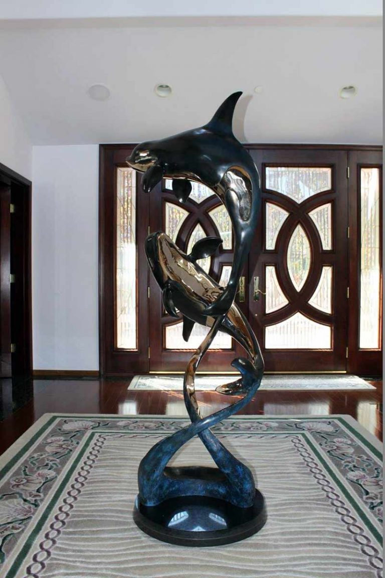 Two Orca’s in a bronze sculpture titled Ocean Romance by Jason Napier