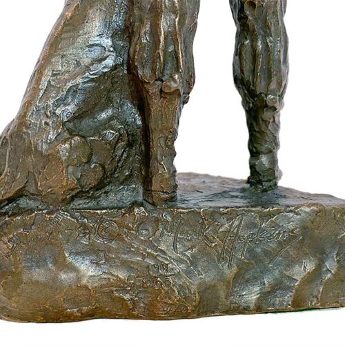 A Mark Hopkins sculpture of a hunter and his dog in bronze