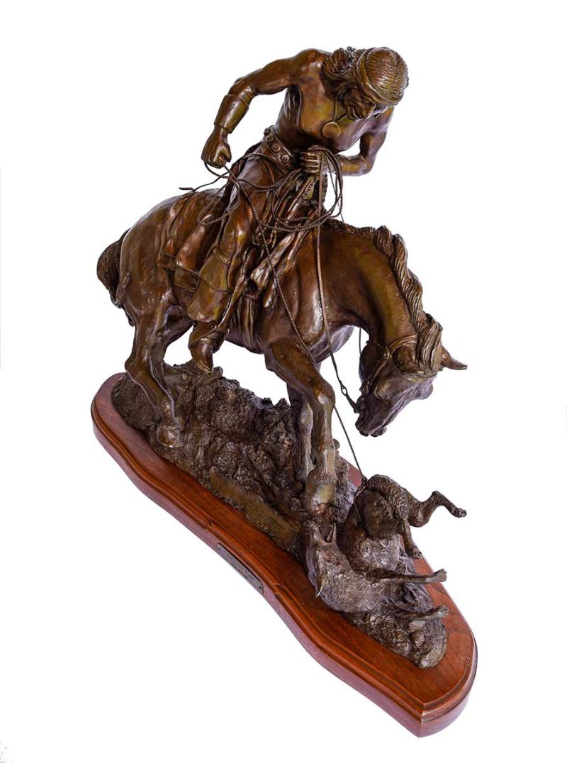 Bronze, "Tightened Play" by Jack Bryant. An Indian seated on a horse holds a lasso. The horse is pawing at a wolf (or some kind of animal) on the ground that the Indian has lassoed.