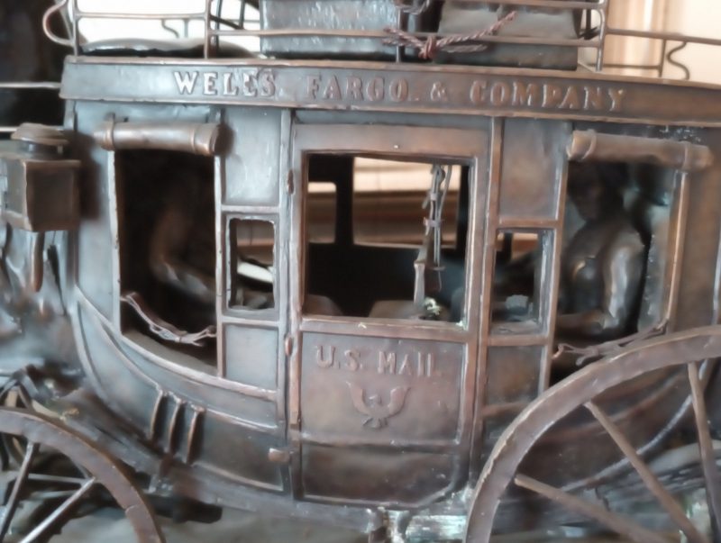 Wells Fargo Stagecoach by noted Montana sculptor-artist Mike Casper. Realistic in every detail, including the passengers in the coach and all the rigging on the 6-horse hitch. Cast for Wells Fargo Bank in 1984