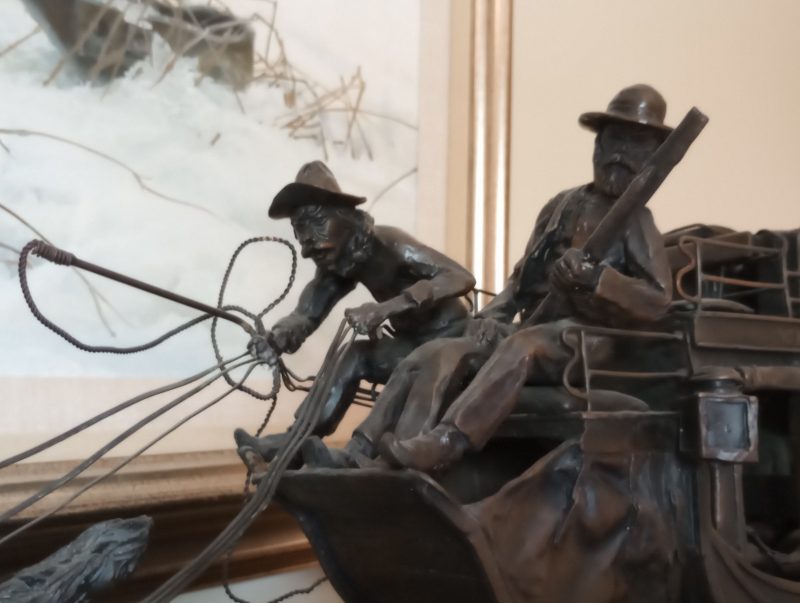 Wells Fargo Stagecoach by noted Montana sculptor-artist Mike Casper. Realistic in every detail, including the passengers in the coach and all the rigging on the 6-horse hitch. Cast for Wells Fargo Bank in 1984