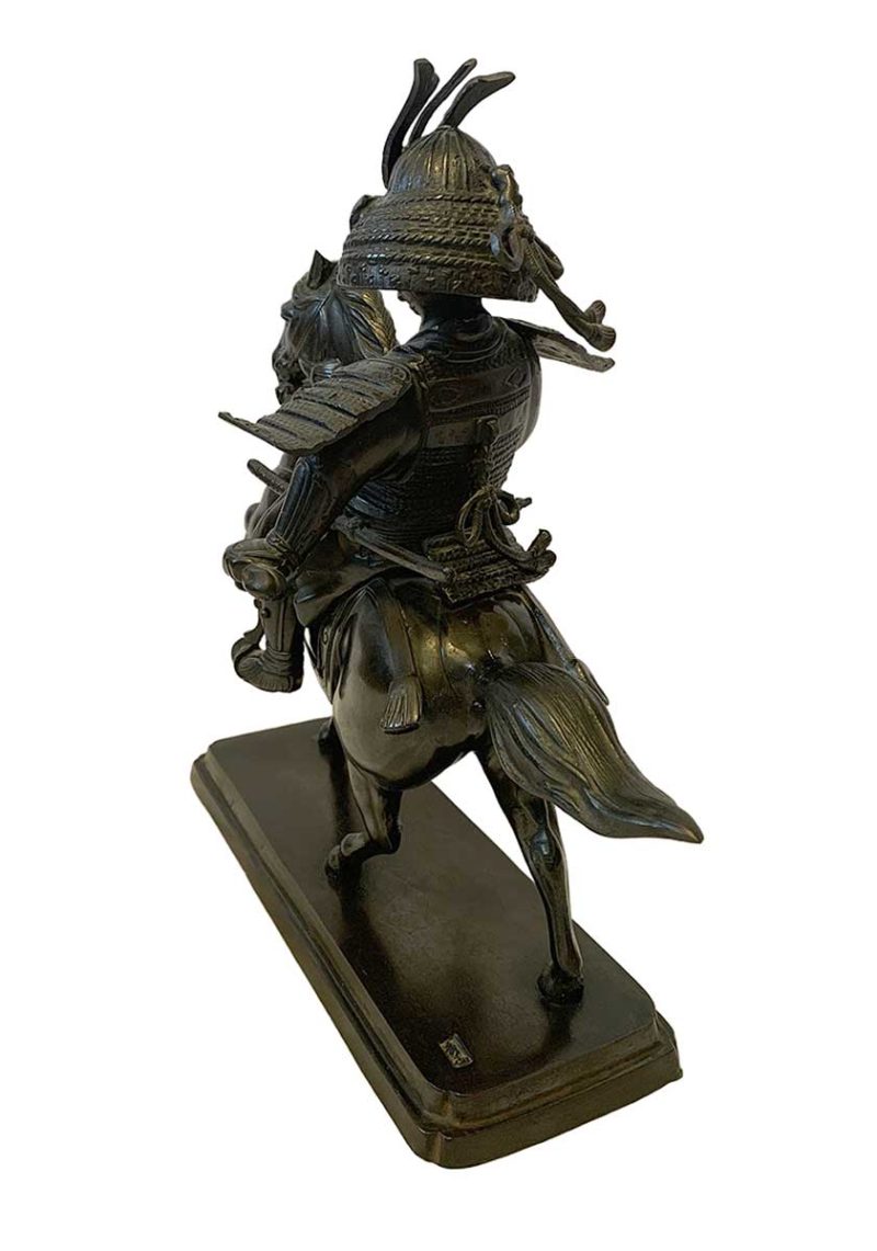 A bronze Samurai on horseback by Syuzan a Handcast Contemporary figure made for GUMP's in Japan by Sento Doki. The Sculpture depicts a medival Japanese warrior in full battle armor astride a prancing mount