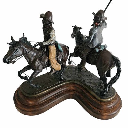 There He Goes is a rare limited edition bronze sculpture of a couple of cowboys out on the range doing what they do to round up cattle by noted sculptor-artist Bob Parks.