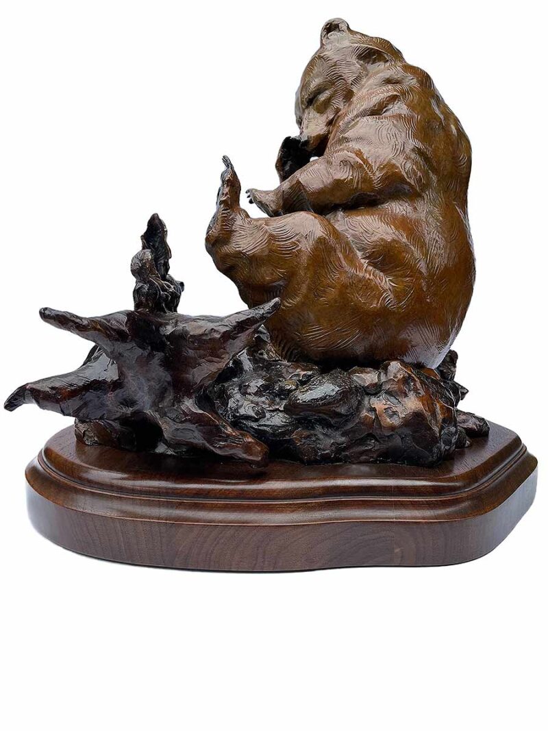 The bronze sculpture titled "Instink" by Walt Horton showcases his renowned skill in capturing playful and tender moments in wildlife.