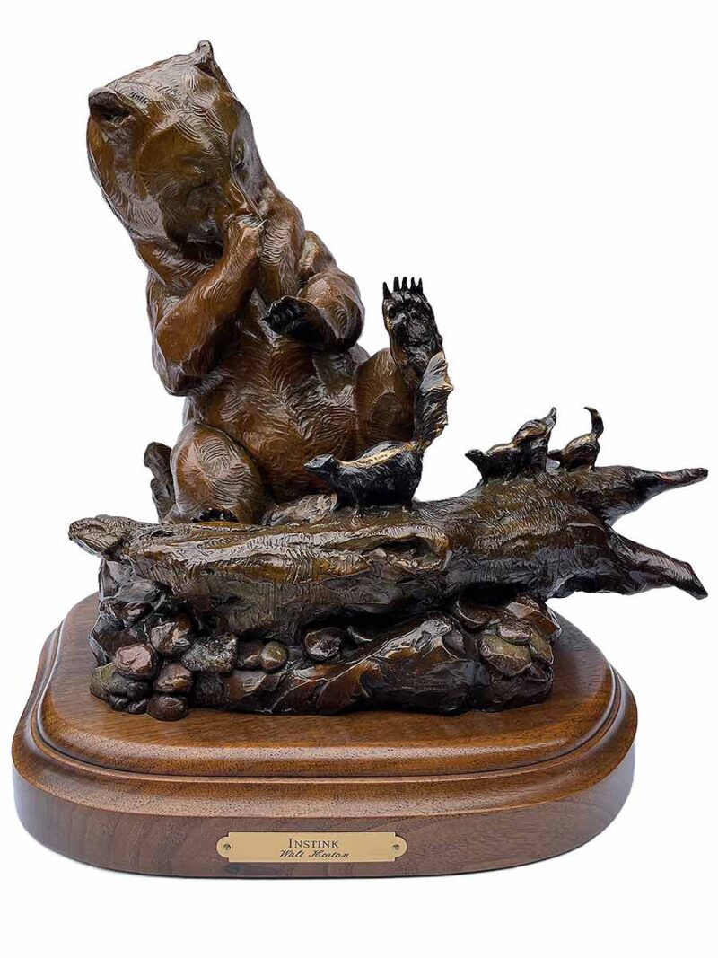 The bronze sculpture titled "Instink" by Walt Horton showcases his renowned skill in capturing playful and tender moments in wildlife.