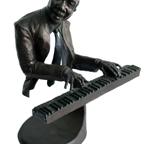 A bronze sculpture titled "Jazz Piano" by Mark Hopkins one of the pieces of the Jazz Musicians Sculpture Group by Mark Hopkins