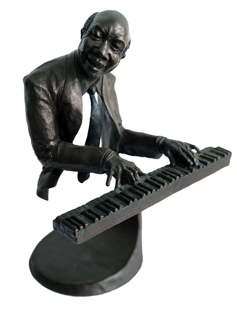 A bronze sculpture titled "Jazz Piano" by Mark Hopkins one of the pieces of the Jazz Musicians Sculpture Group by Mark Hopkins