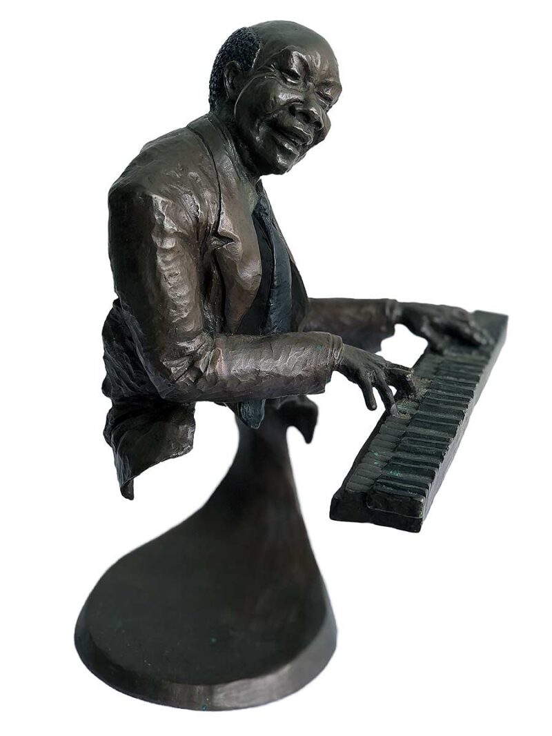 A bronze sculpture titled "Jazz Piano" by Mark Hopkins one of the pieces of the Jazz Musicians Sculpture Group by Mark Hopkins