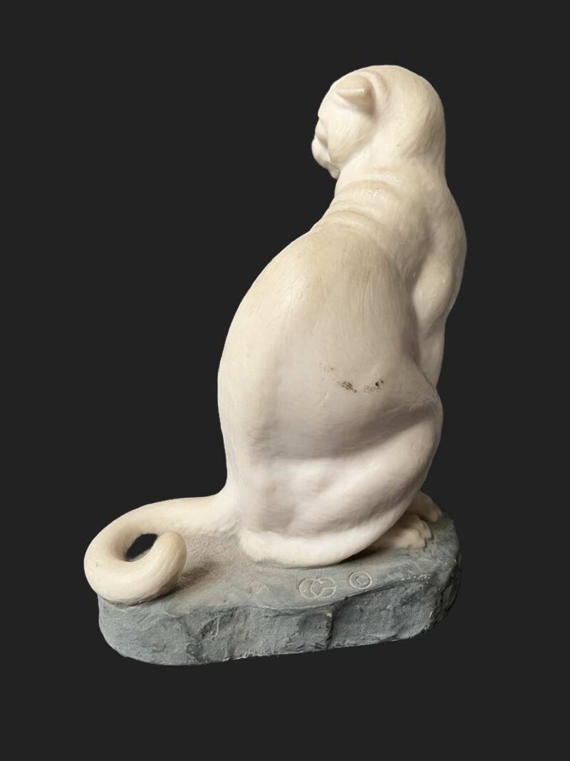 A bronze sculpture titled "Cougar"(ttb) by noted sculptor-artist JL Boulton one of his many nicely carved Alabaster sculptures.