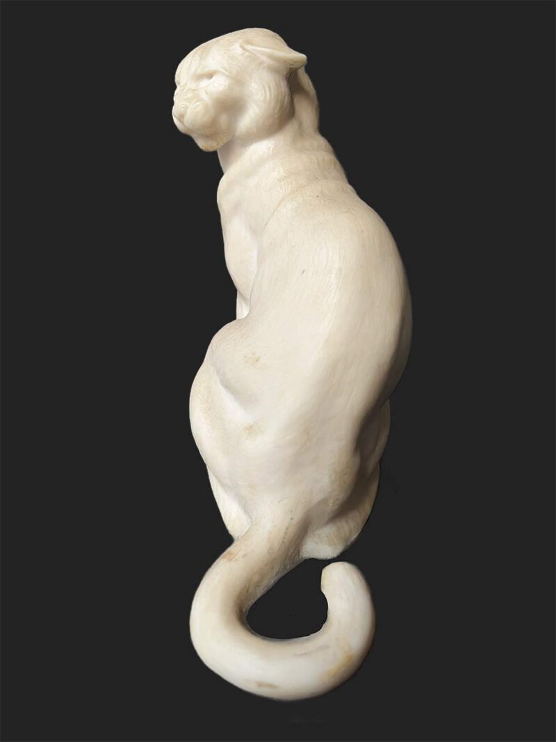 bronze sculpture titled "Cougar"(ttb) by noted sculptor-artist JL Boulton one of his many nicely carved Alabaster sculptures.