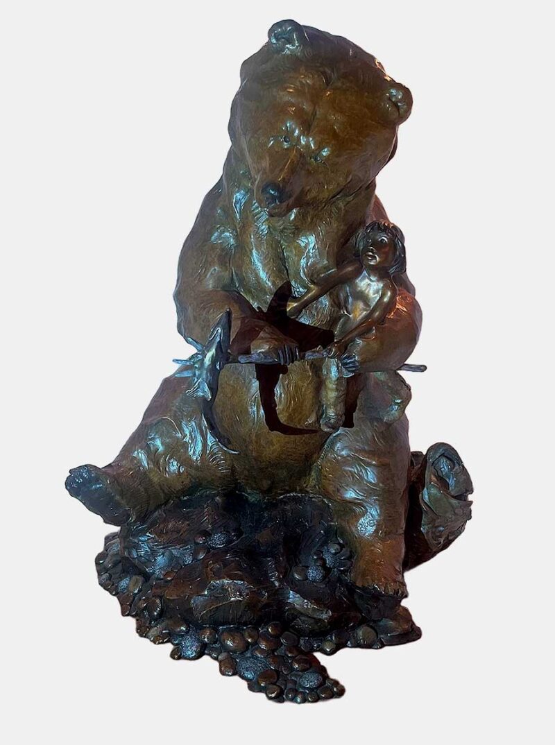 This bronze bear sculpture brings a sense of humor, complexity, and even humility to the theme of Ransom. Created by Walt Horton it features a large bear in an upright, almost human-like stance, holding a young boy in one paw and a fish has been speared by the young boy fish in the other. The scene is whimsical, suggesting that the bear is either demanding a trade for the fish or holding the fish as leverage in a humorous negotiation.