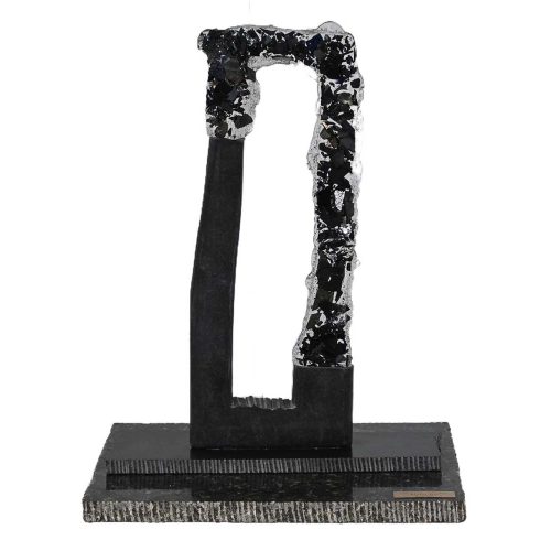 An abstract mixed metal and stone sculpture titled Shifted Stance by the contemporary American artist Matthew Fine, created circa March 2000. The work is constructed from industrial metal elements combined with a textured stone or composite base, forming a vertical architectural composition with a recessed interior void and heavily worked surfaces. Available now on SculptureCollector.com, the premier platform for purchasing or reselling creative sculptures securely and privately.